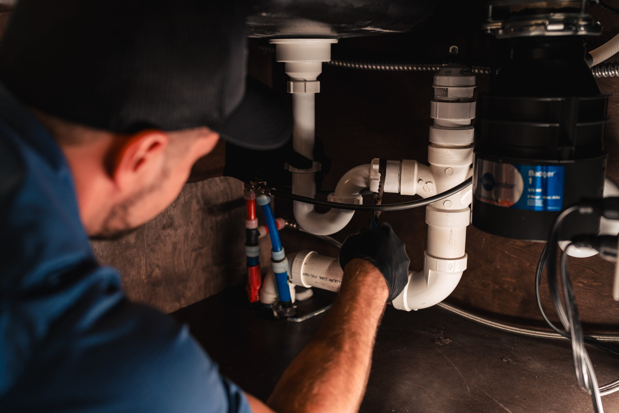 man fixing pipe