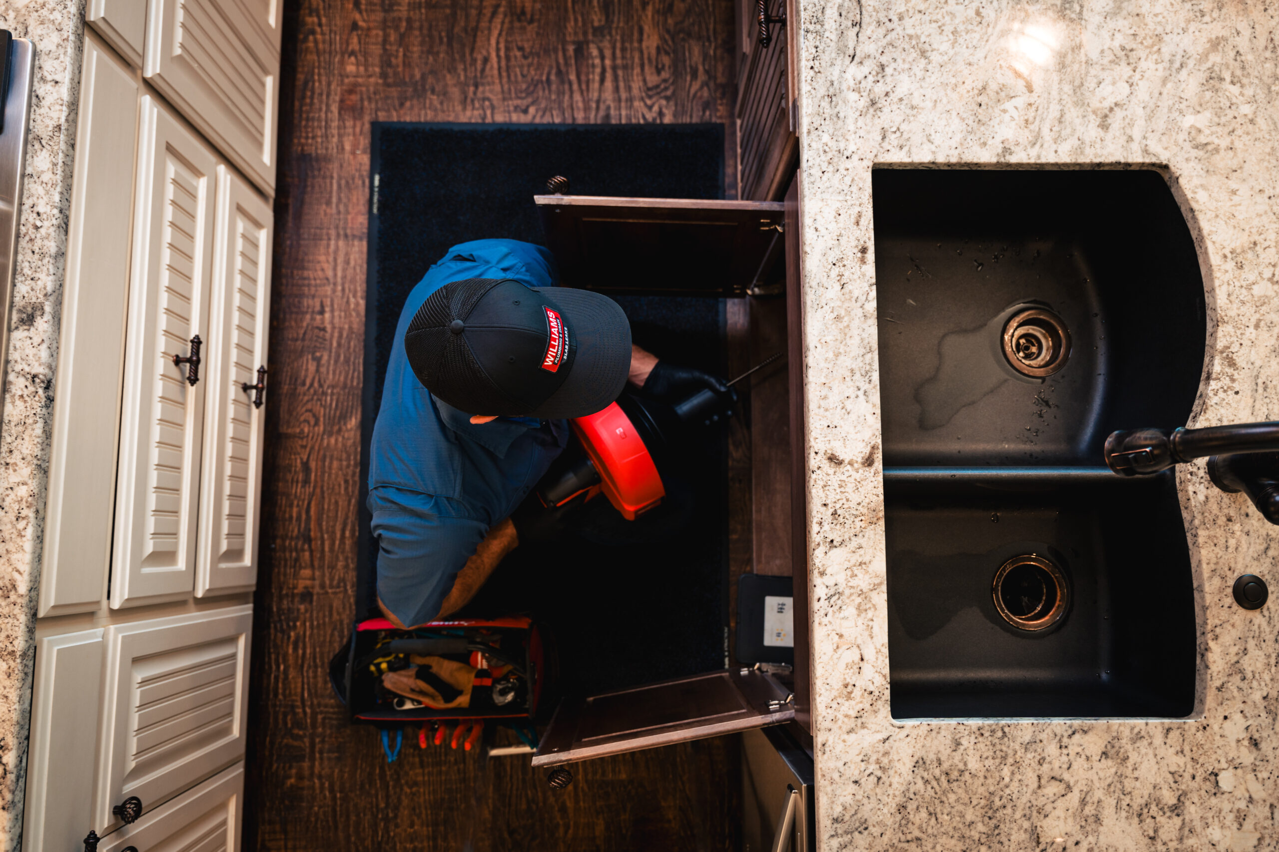 man fixing faucet pipe