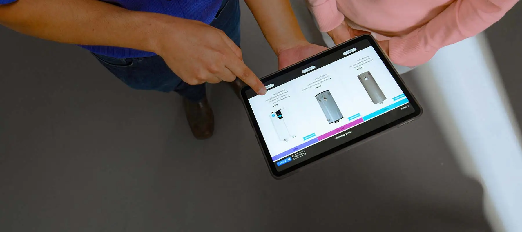 Customer reviewing energy-efficient water heater options with a plumbing professional on a tablet